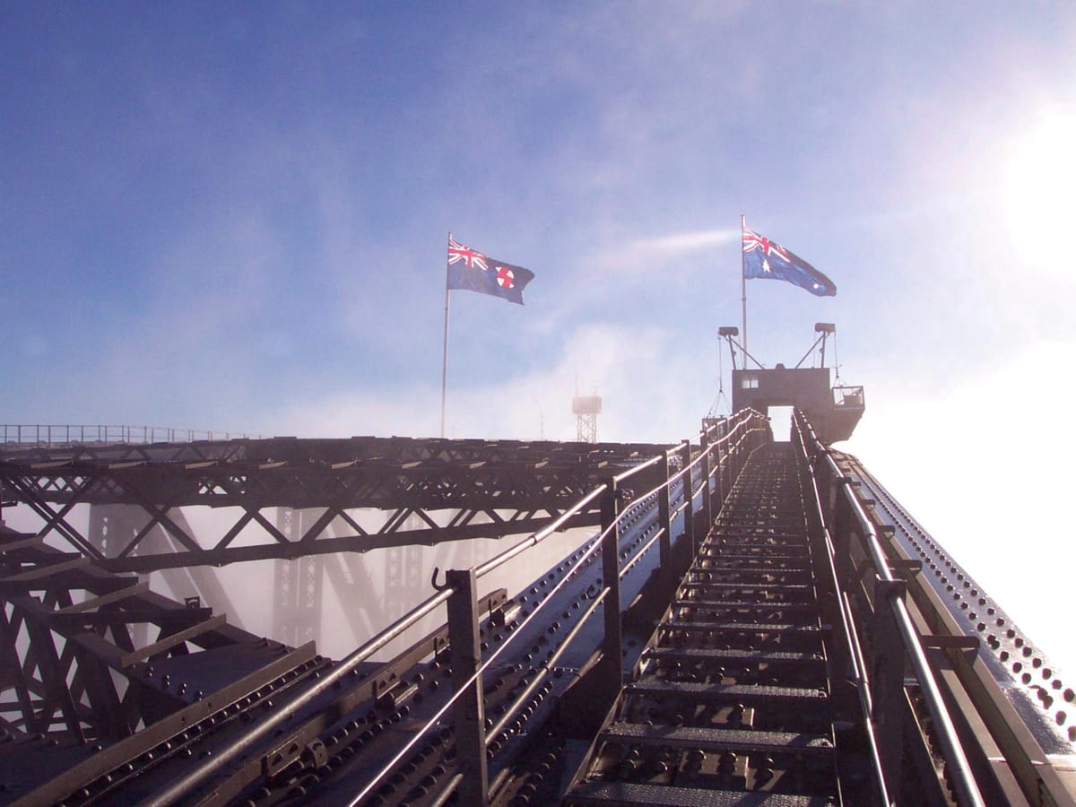 Taken from the ascent up the right hand side of the bridge focusing on the steel path to Australian flags flying at the pinnacle.