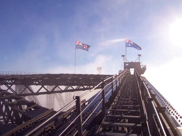 Taken from the ascent up the right hand side of the bridge focusing on the steel path to Australian flags flying at the pinnacle.